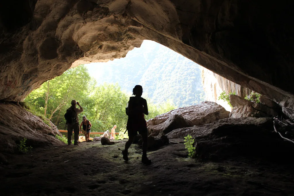 Visitors at the entrance to Pëllumbas Cave.