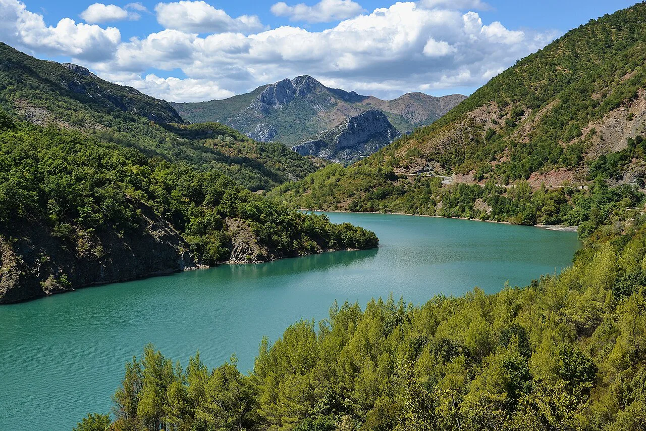 Lake Shkopeti between wooded hills in Albania.