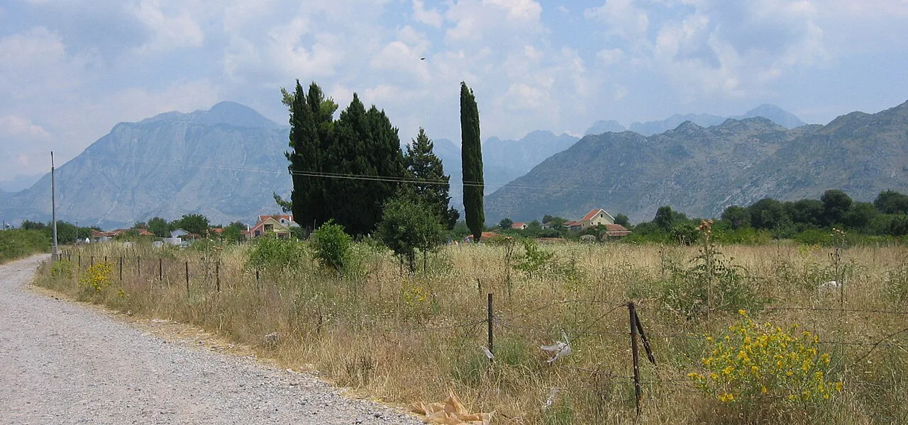 The Albanian Alps seen across fields near Koplik.