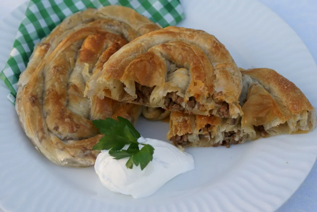 Albanian byrek served with yoghurt.