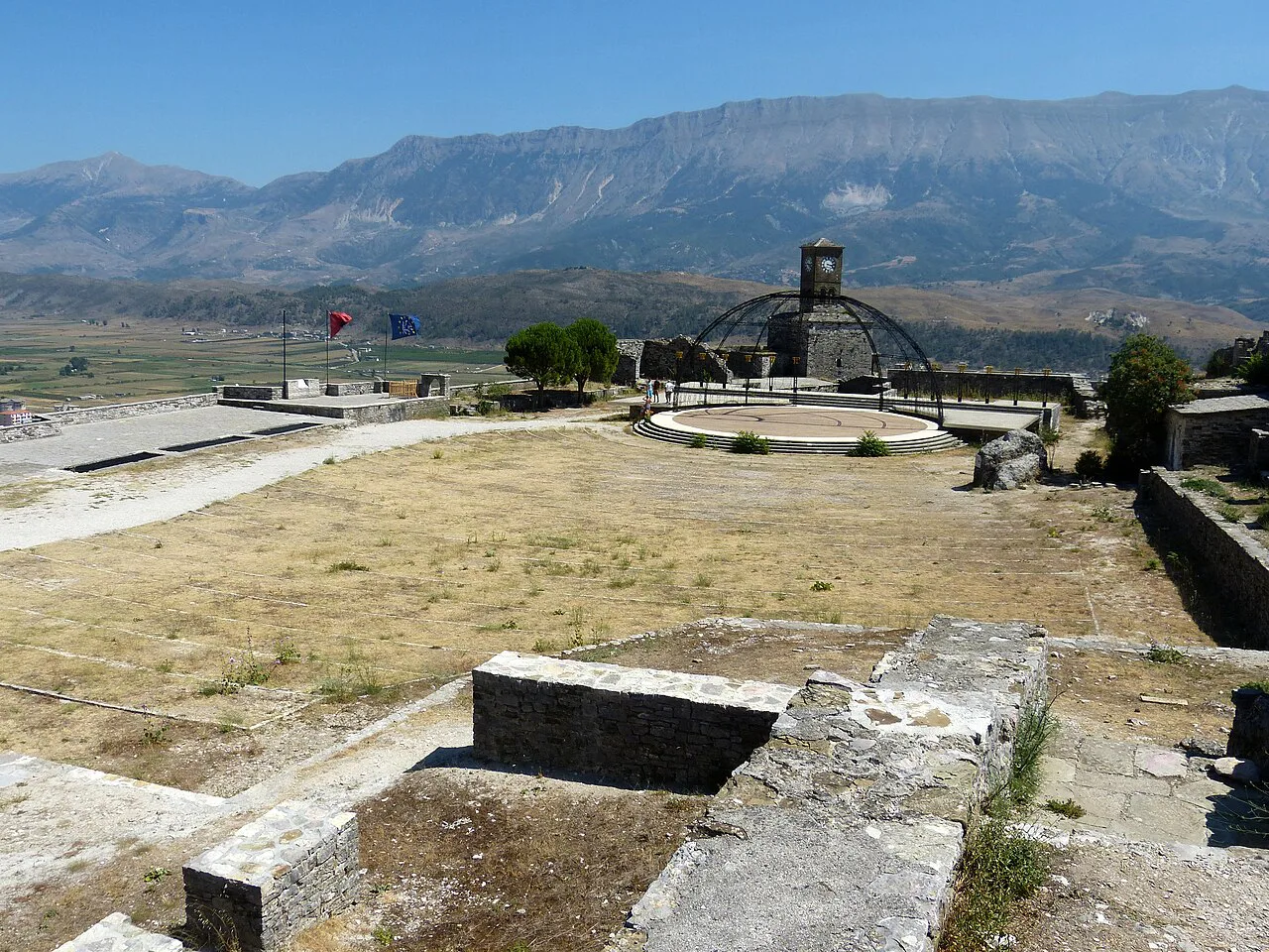 The folk festival grounds in Gjirokastër Castle with mountains beyond.