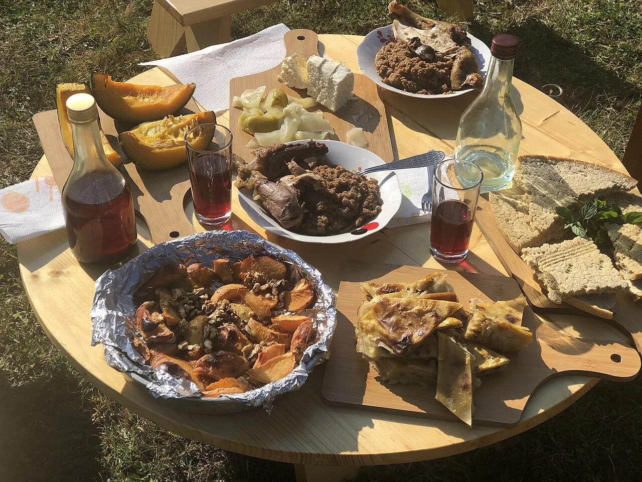 A guesthouse spread of cornbread, cheese, pickles and baked dishes served with raki.