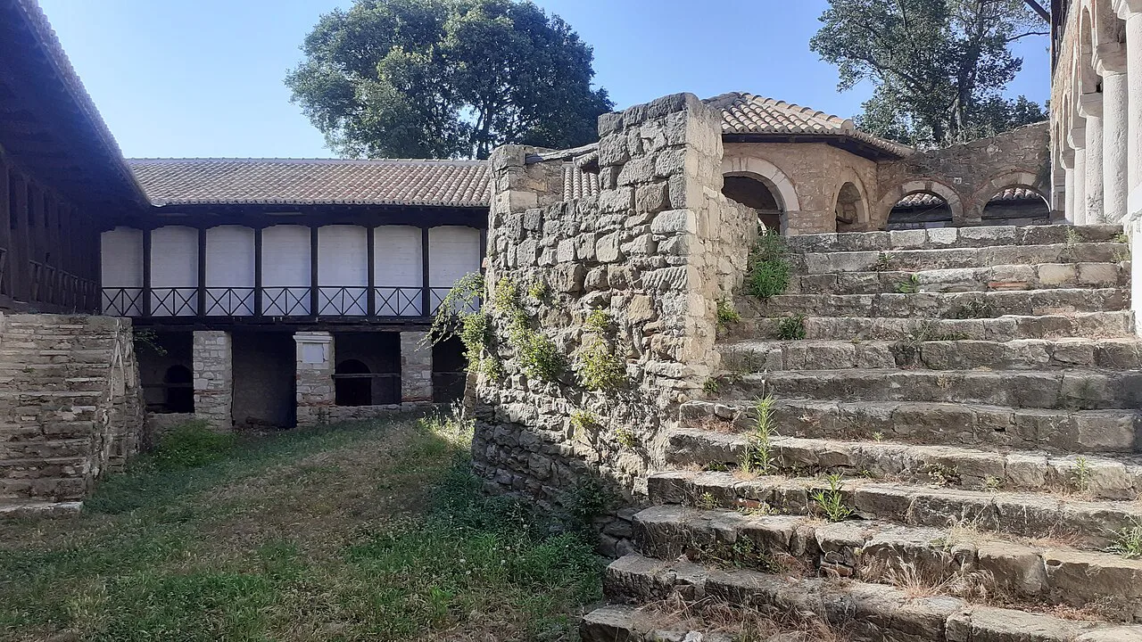 Stone steps and wooden galleries in the courtyard of Ardenica Monastery.
