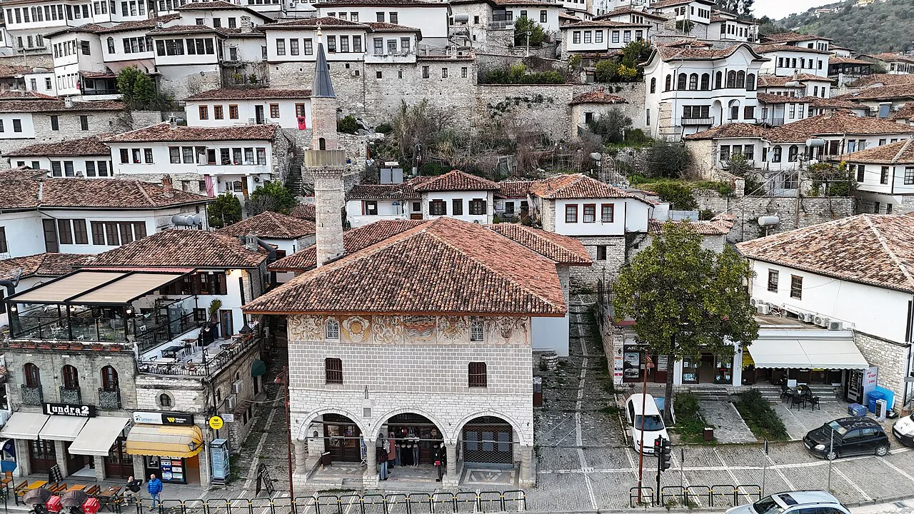 Aerial view of the Bachelors' Mosque in Berat, with the old town houses rising behind.