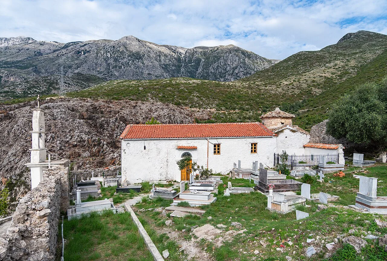 St Mary's Monastery Church and its cemetery above Dhërmi, with the Ceraunian Mountains behind.