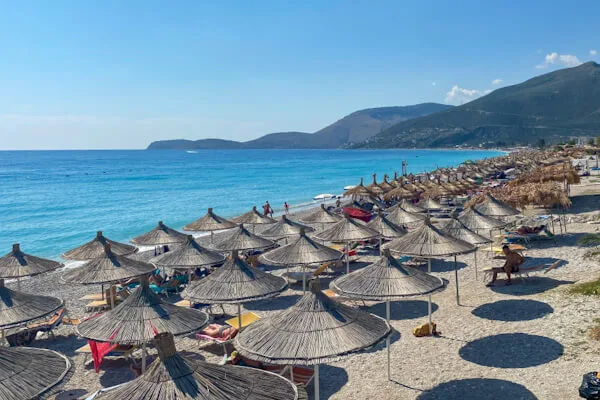 Straw parasols and sunbeds on the beach at Borsh.