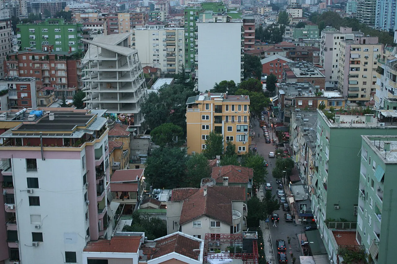 Apartment blocks and streets of Tirana seen from above.