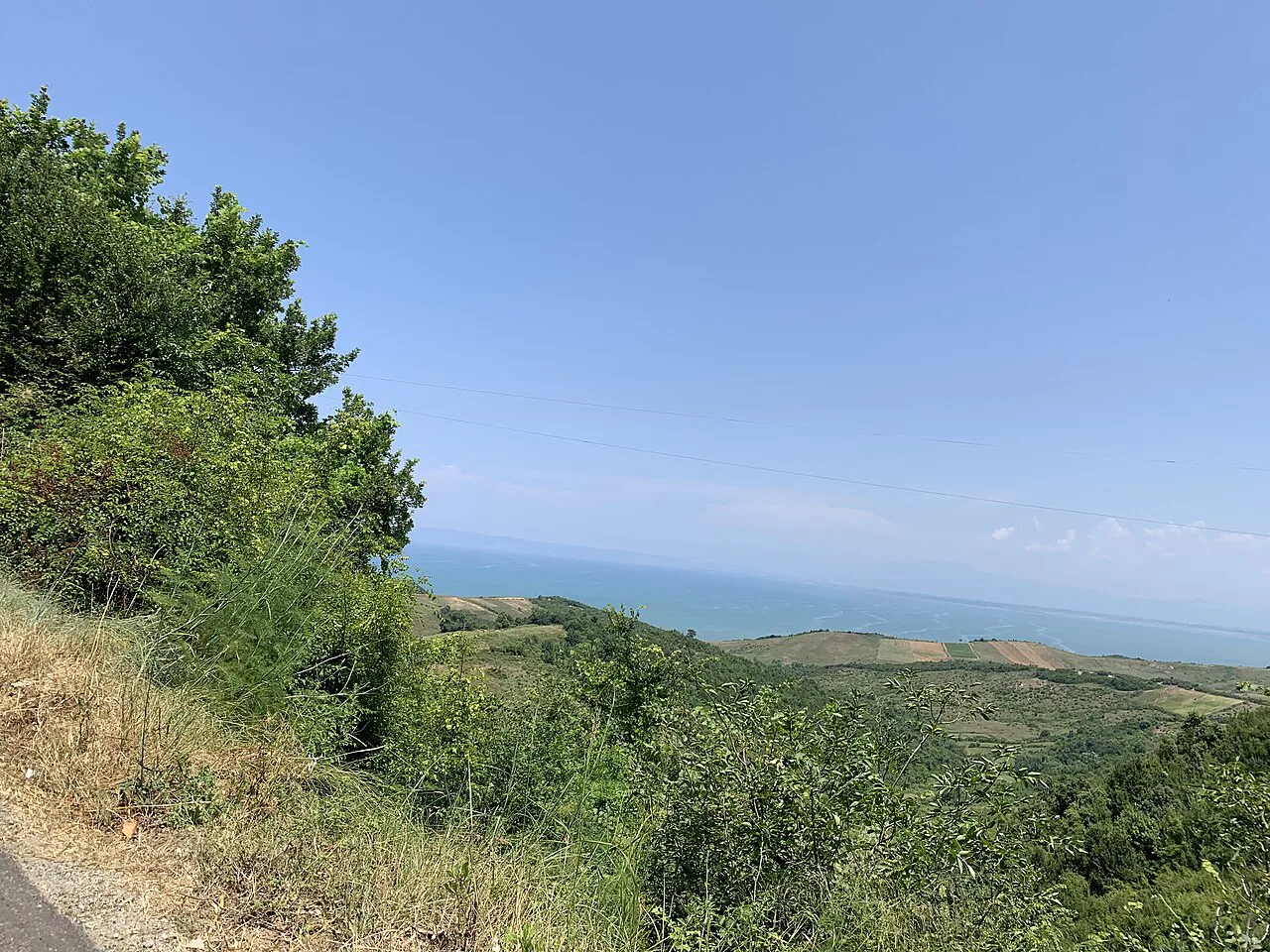 Green slopes and the Adriatic coast at the Cape of Rodon.
