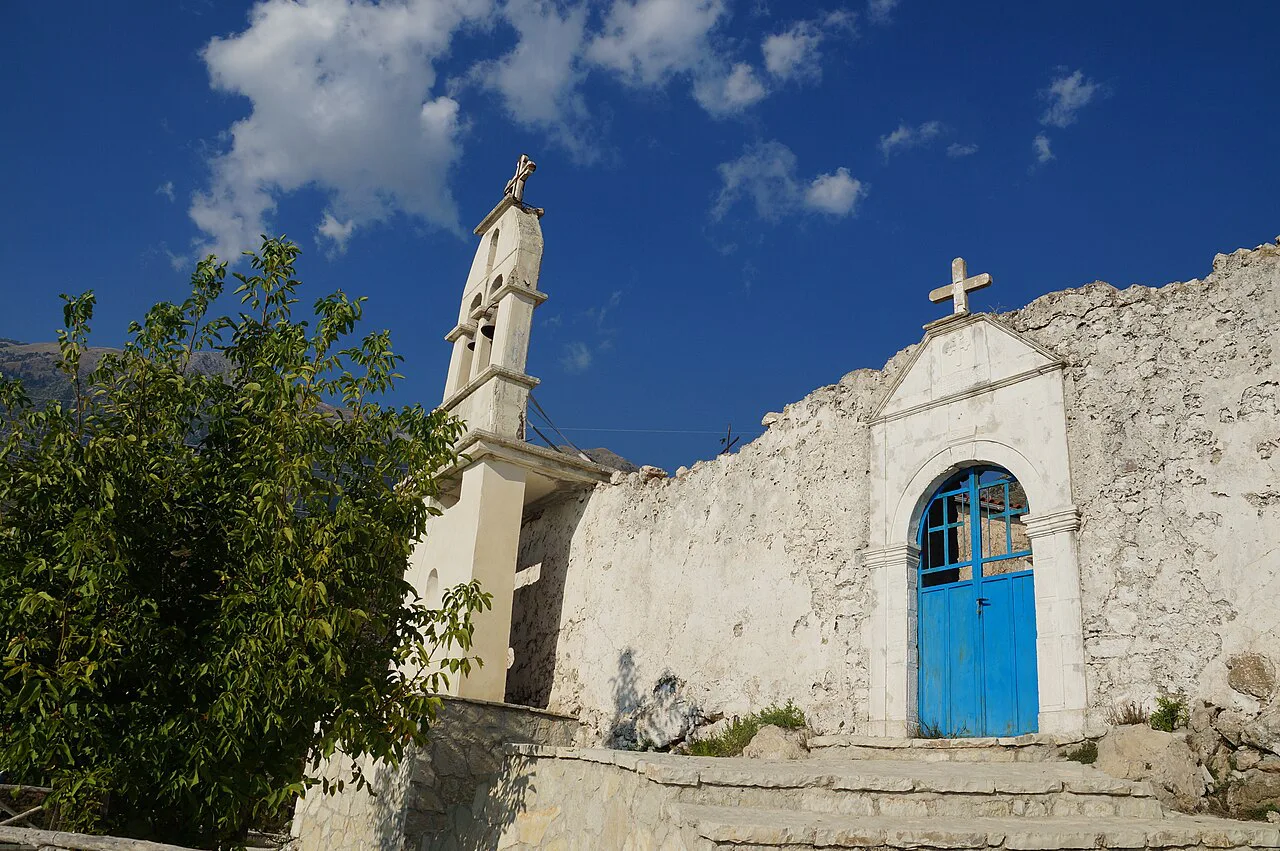 The entrance and bell tower of St Mary's Church at the monastery in Dhërmi.