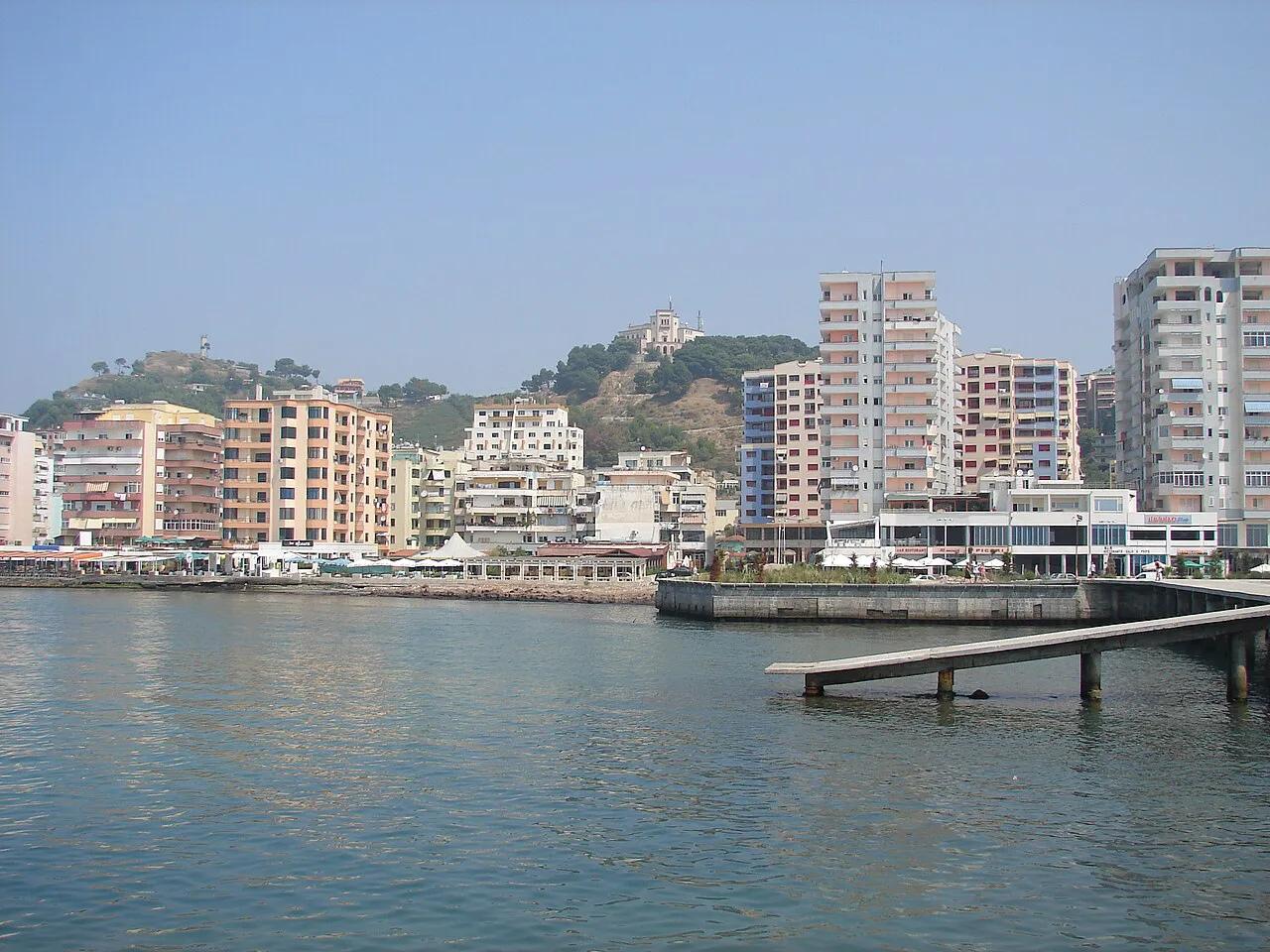Apartment blocks and a pier along the Durrës waterfront.