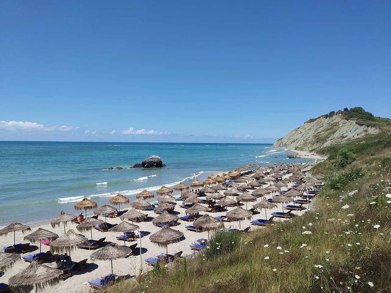 Straw parasols lined up on Portez beach near Durrës.