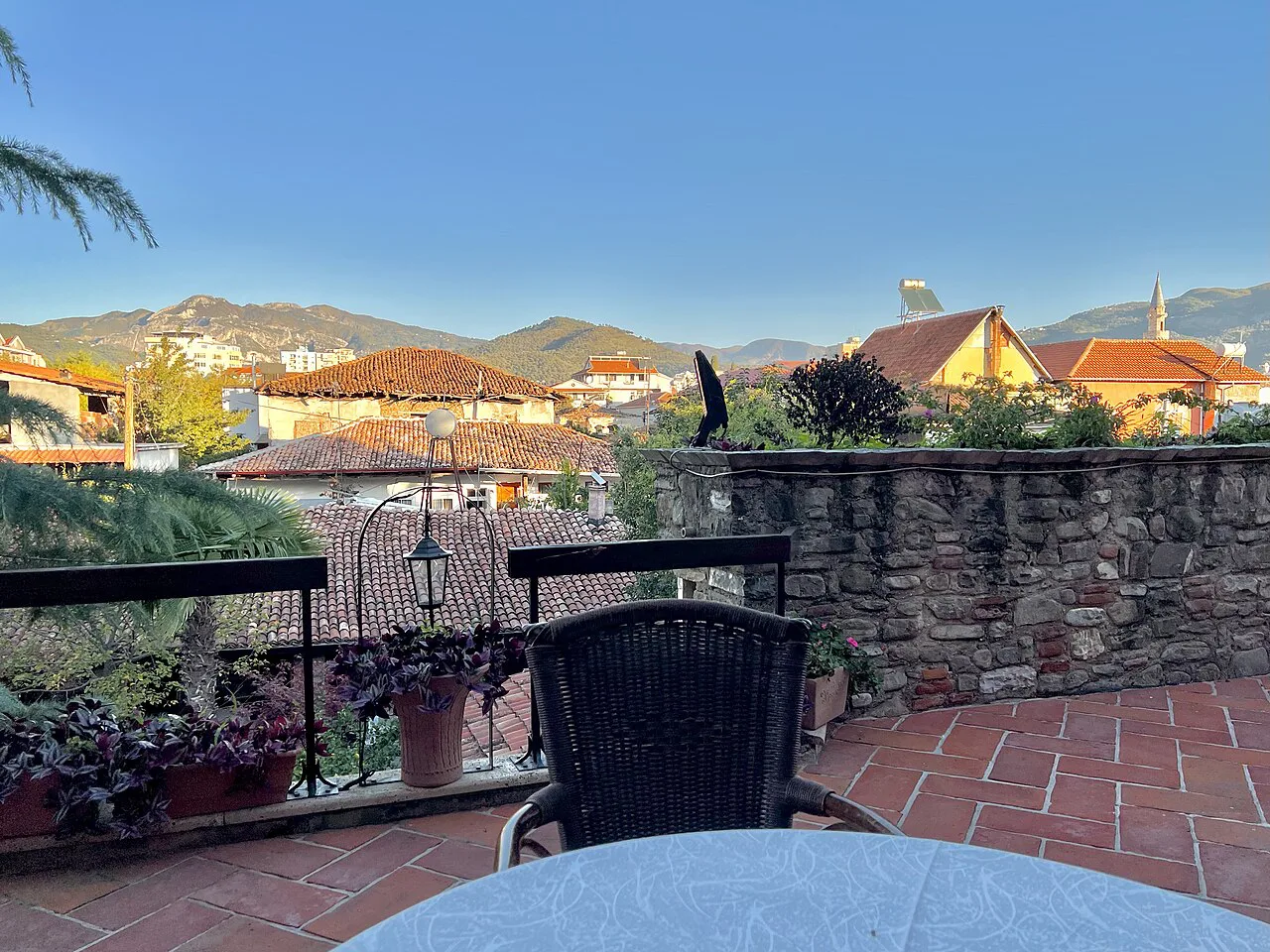 A morning view over Elbasan's rooftops and hills from a terrace.