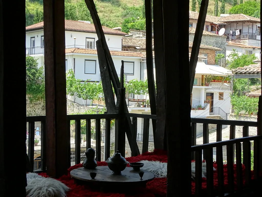 A traditional upstairs room with a view through the timber window inside the Ethnographic Museum in Berat.
