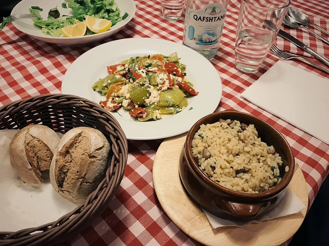 Fërgesë and tavë with rice served on a restaurant table.