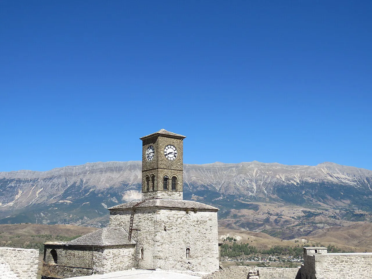 The Clock Tower of Gjirokastër against the surrounding mountains.