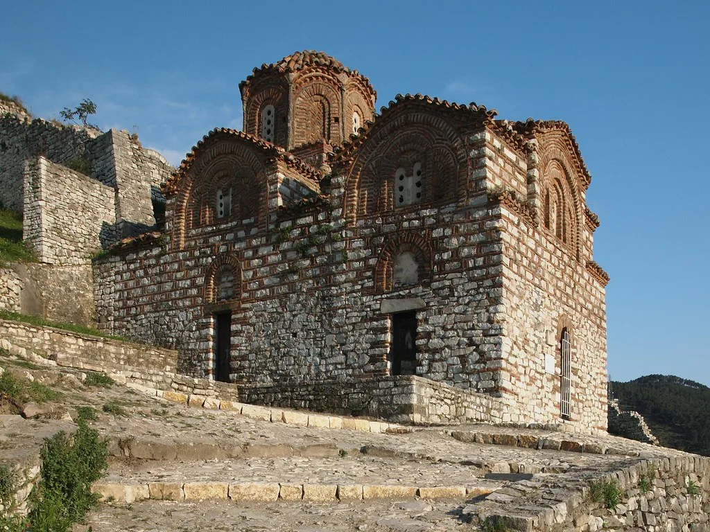 The Byzantine-style Holy Trinity Church in Berat Castle under a clear blue sky.