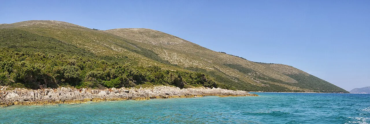 Green hills of the Karaburun Peninsula above the clear waters of the Bay of Vlorë.