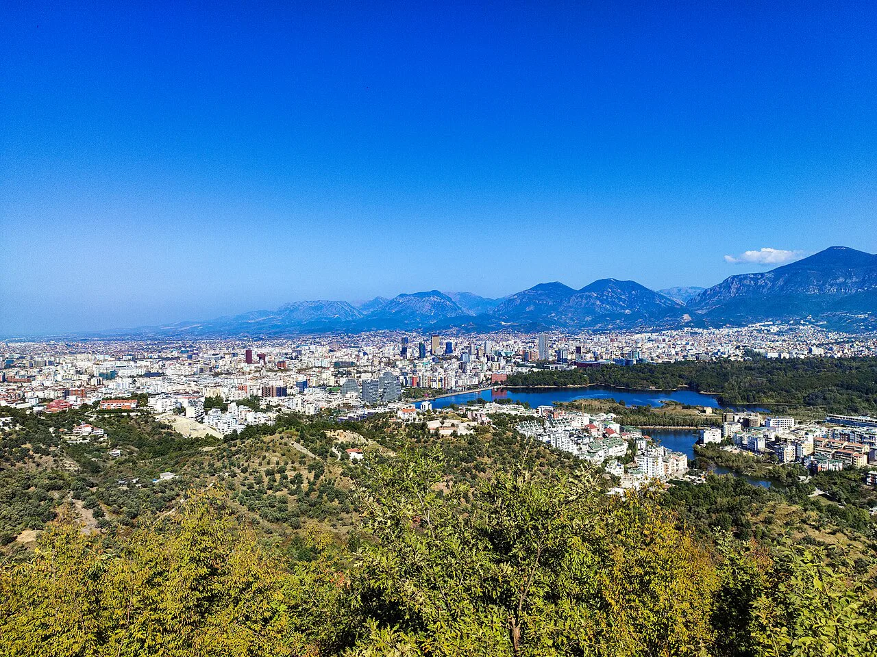 A wide view over Tirana and its plain towards the mountains.