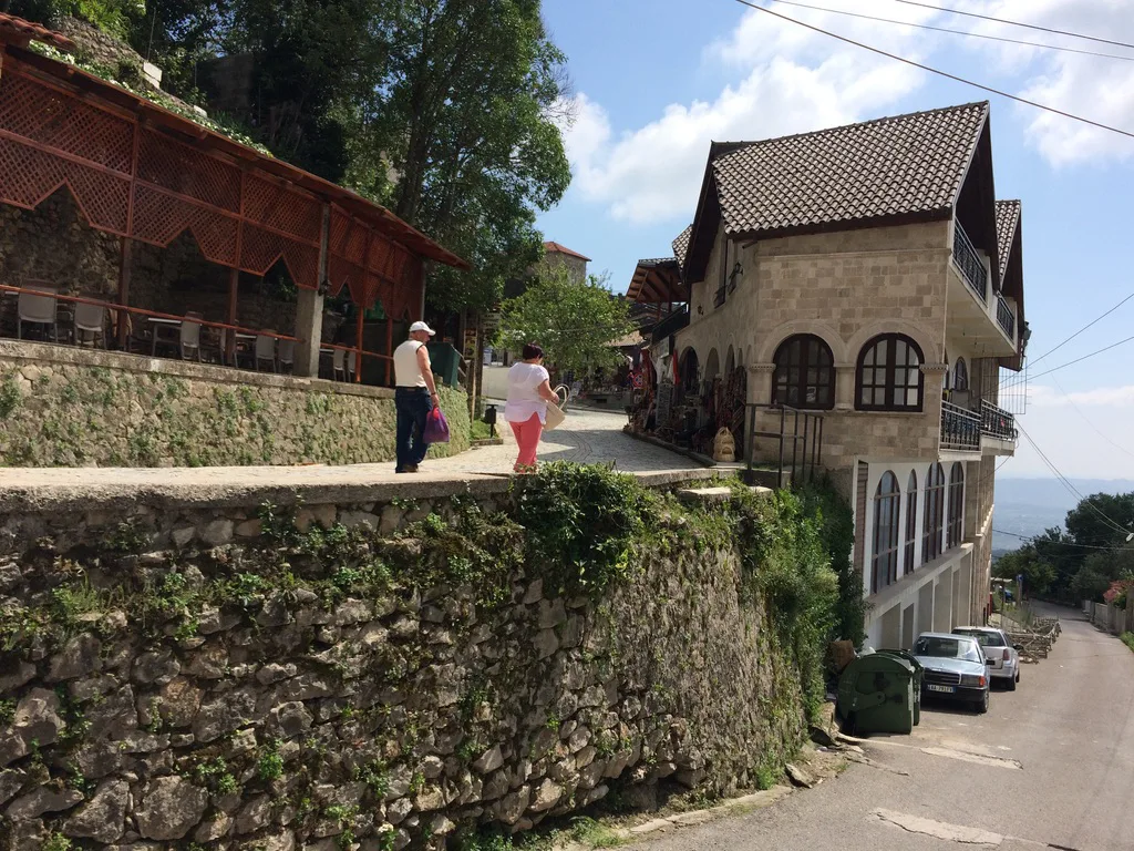 A cobbled street with traditional buildings in Krujë.