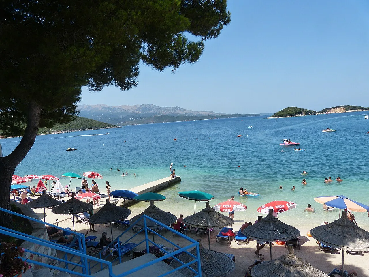 Parasols on the beach at Ksamil with its small islands offshore.