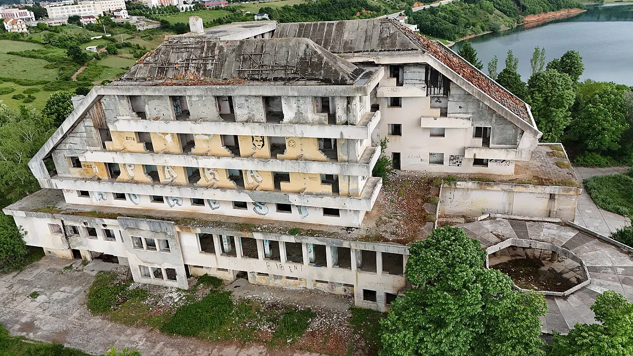 The abandoned Hotel Turizmi above the lake in Kukës.