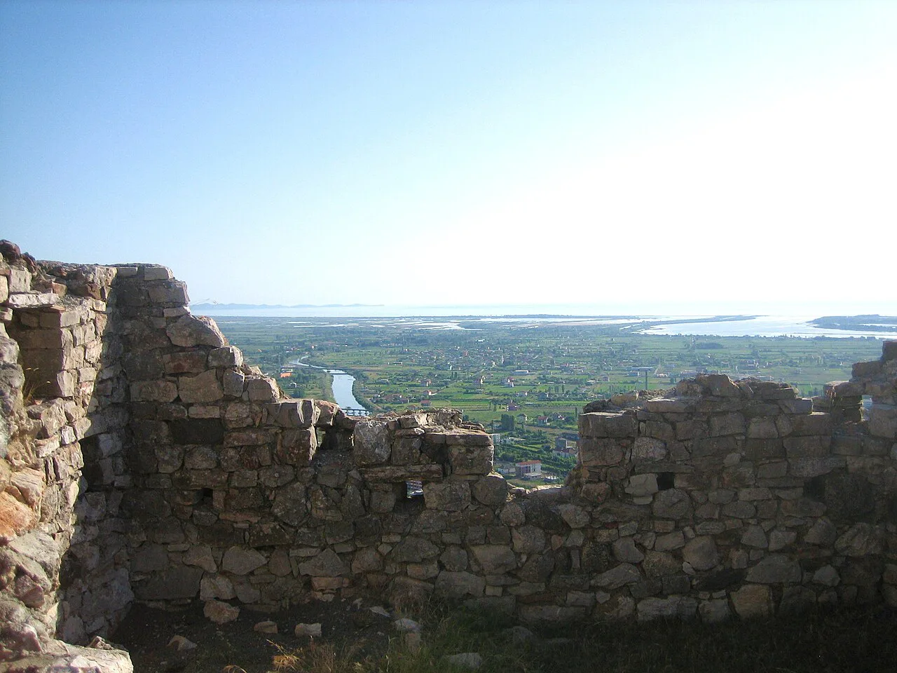 A ruined wall of Lezhë Castle with a view over the city and plain.