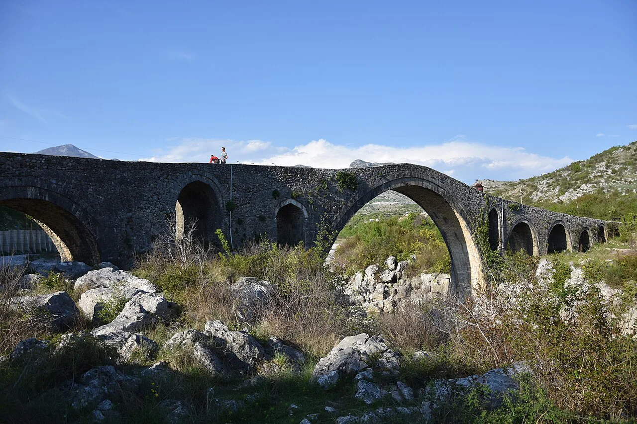 The stone arches of the Mes Bridge seen from below.