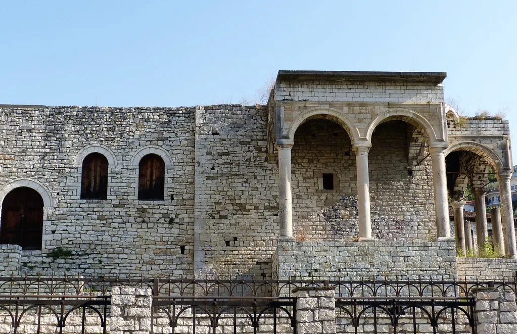 A historic stone building with an arched loggia in Berat.
