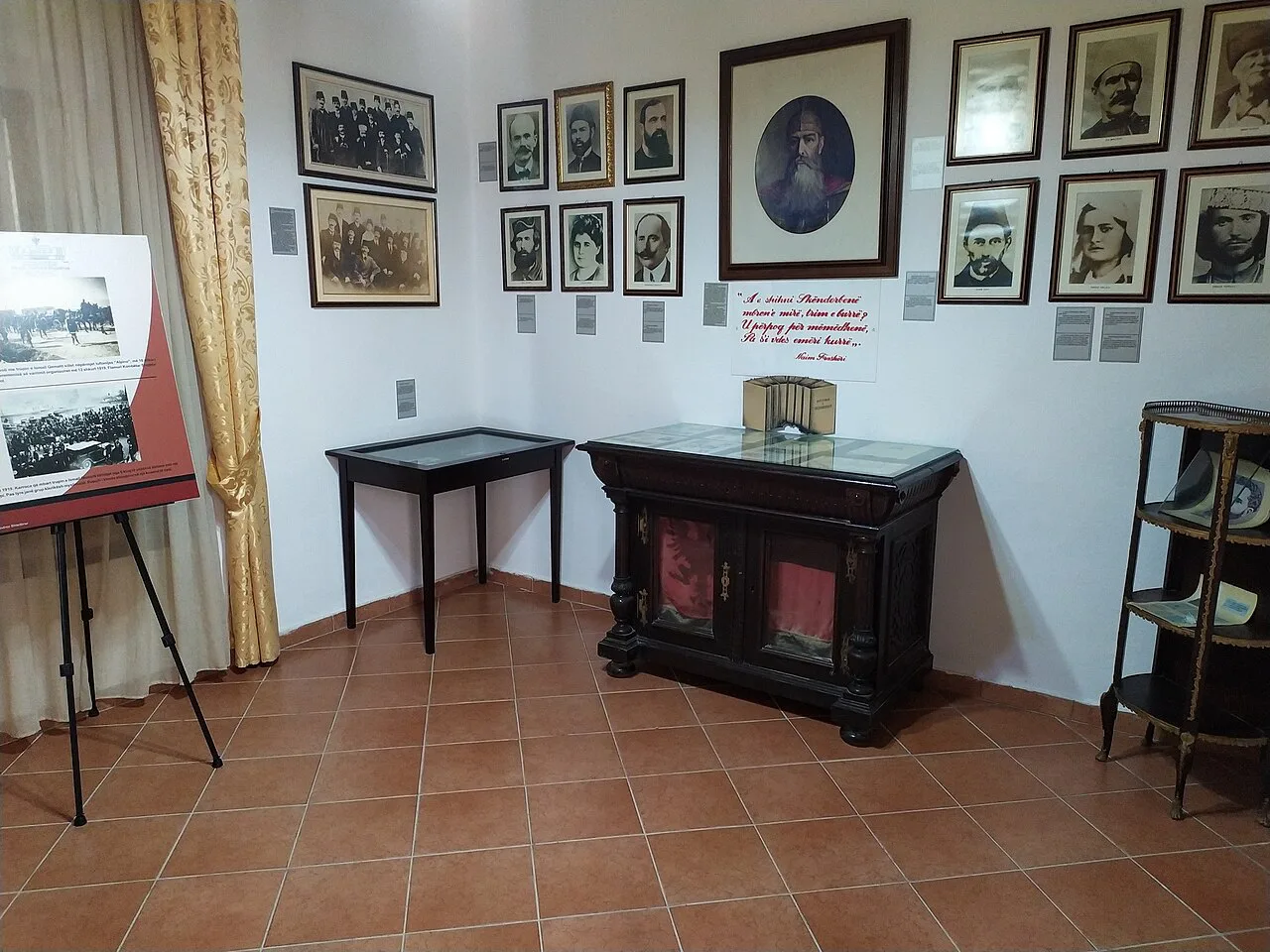A room of portraits and period furniture inside the Independence Museum in Vlorë.