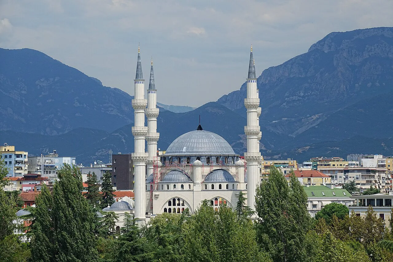 The Namazgah Mosque in Tirana nearing completion, with the mountains behind.