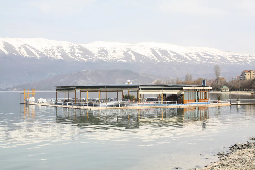 Lake Ohrid at Pogradec with snow-capped mountains behind.