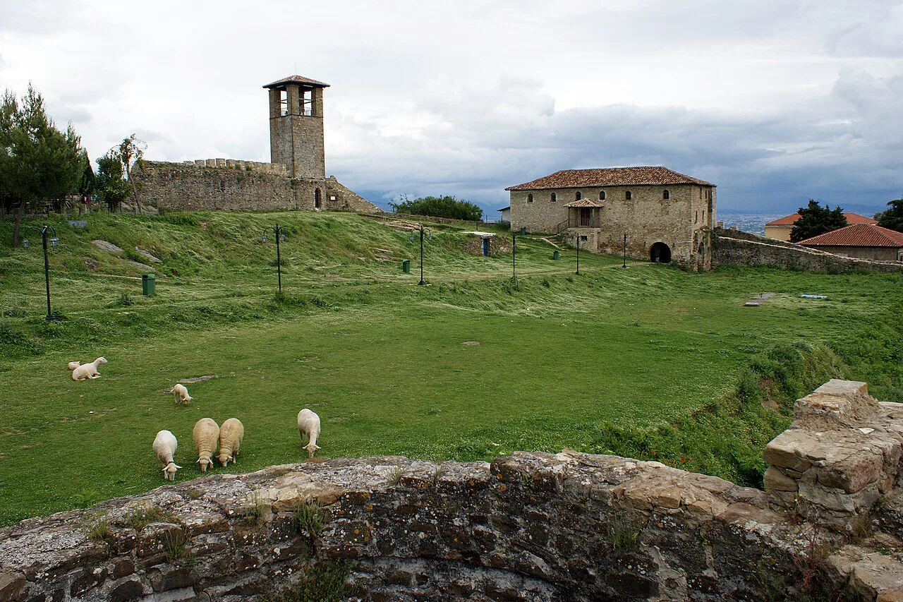 The grassy interior of Prezë Castle, looking towards the clock tower.