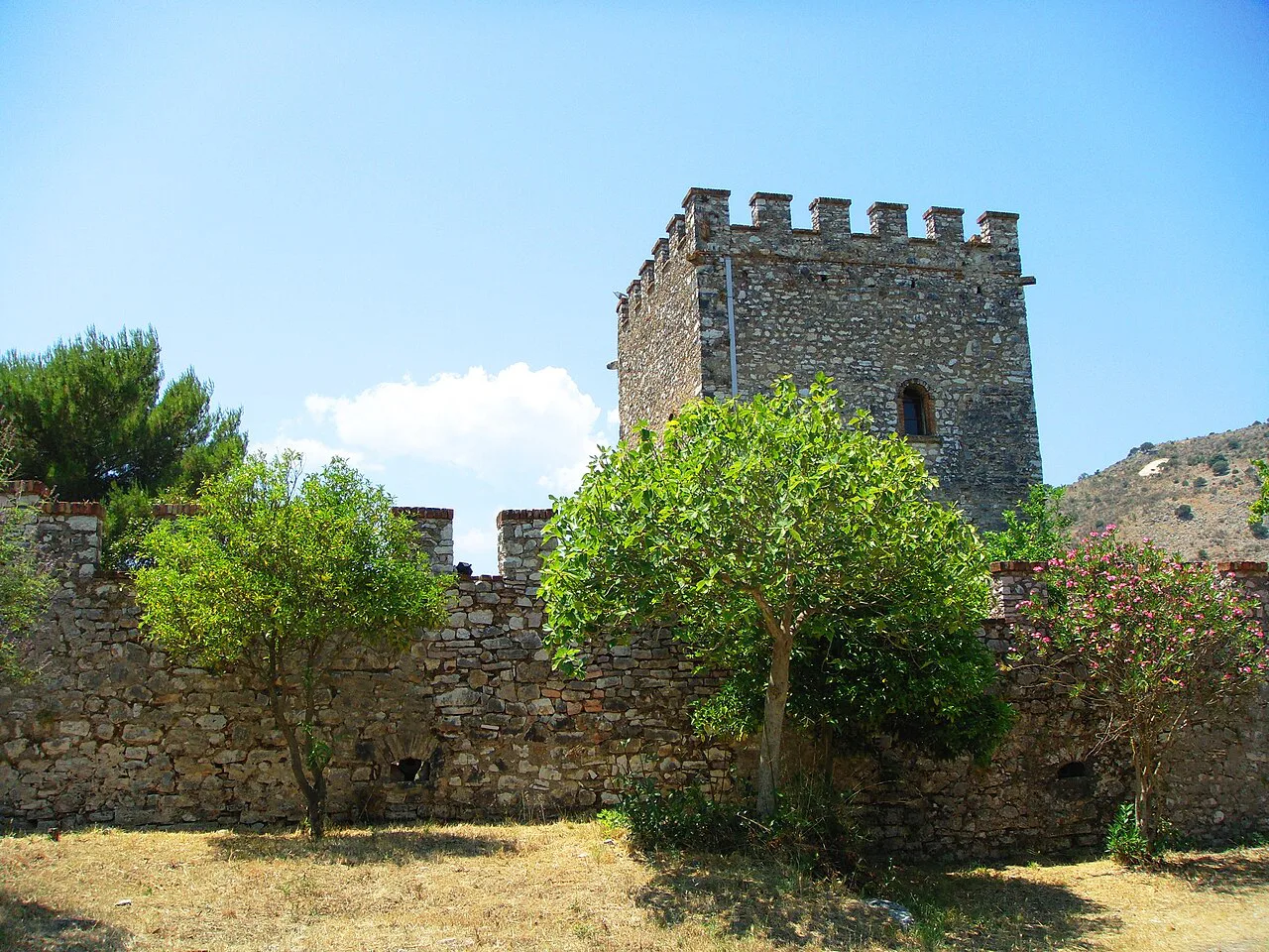 A crenellated stone castle tower in the Sarandë district.