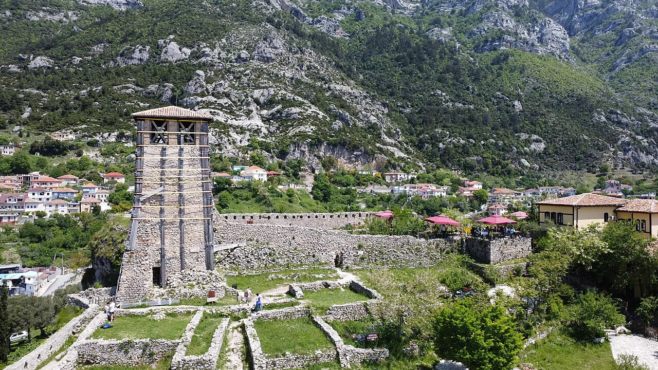 The watchtower of Krujë Castle against the mountains above the town.
