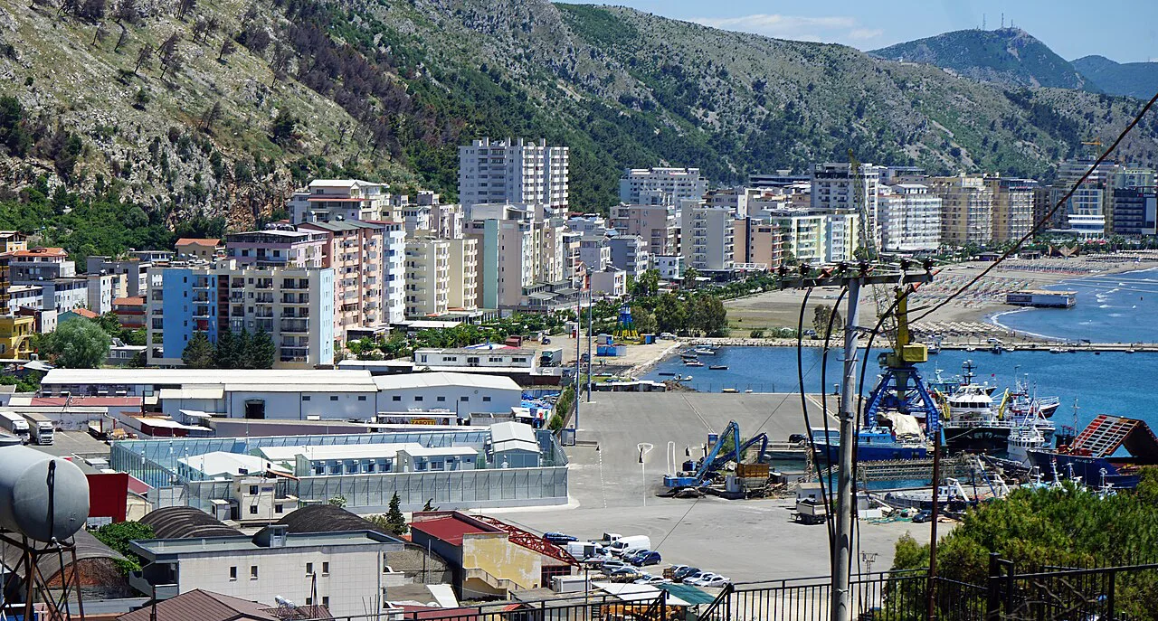 Shëngjin's port and hotels below the mountains.