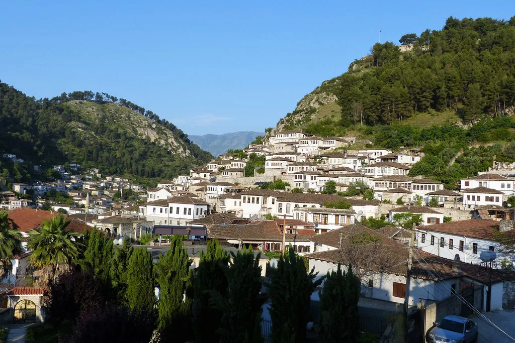 Whitewashed Ottoman-era houses climbing the wooded hillside in Berat.