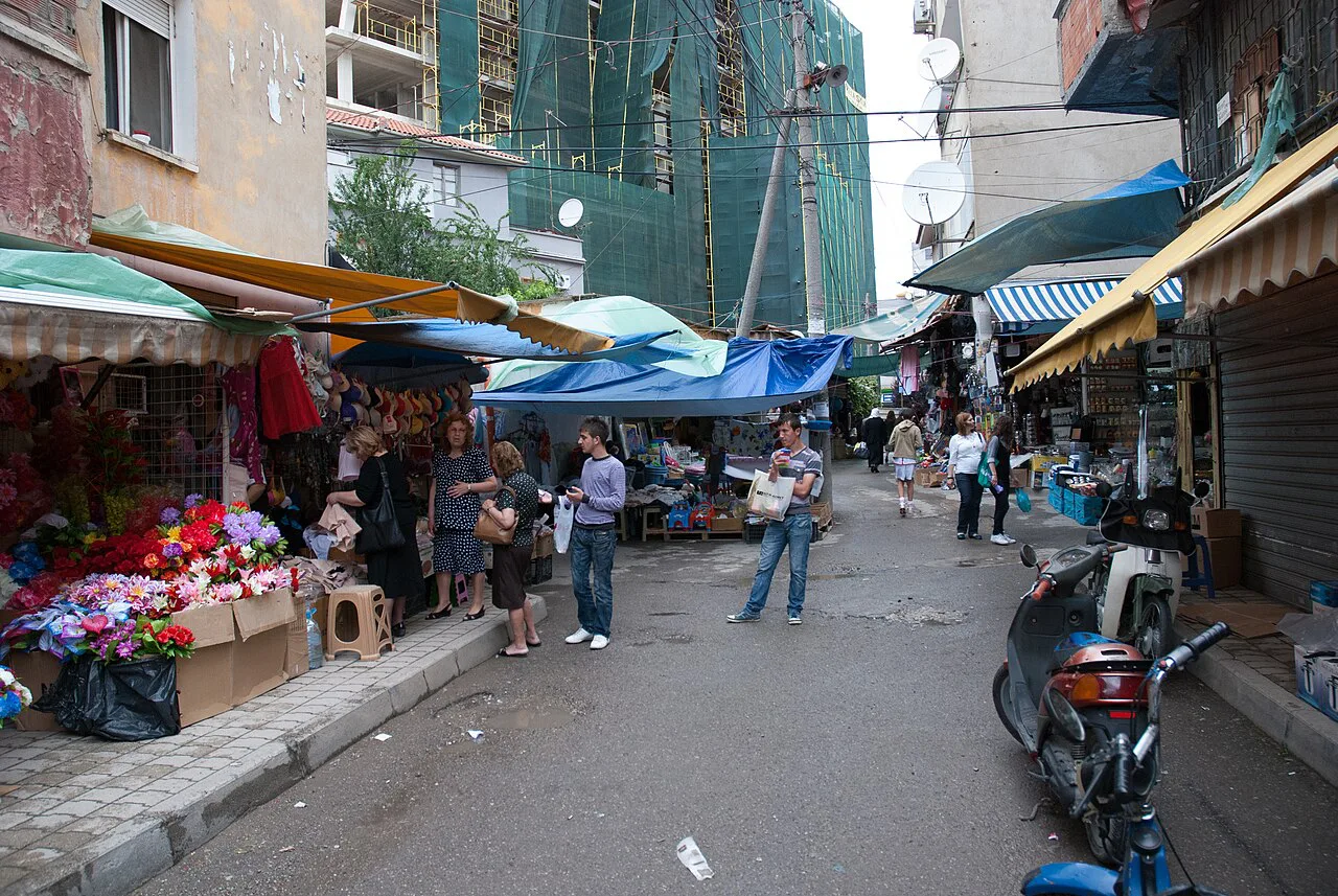 Stalls and shoppers on a market street in Tirana.