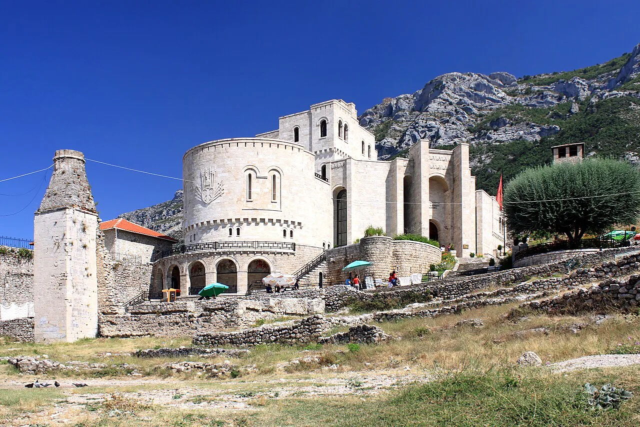 The Skanderbeg Museum inside the walls of Krujë Castle, with mountains behind.
