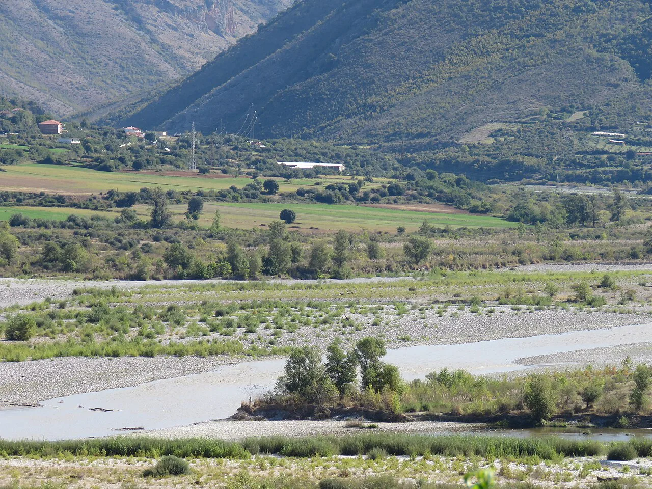 The wide gravel bed where the Drino meets the Vjosë near Tepelenë.