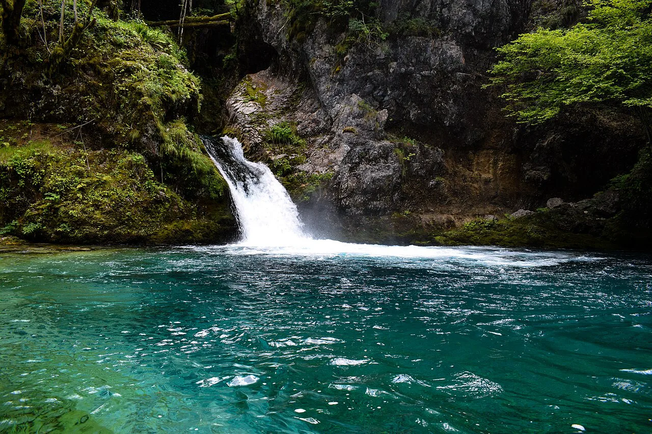 A waterfall pouring into the Blue Eye pool near Theth.