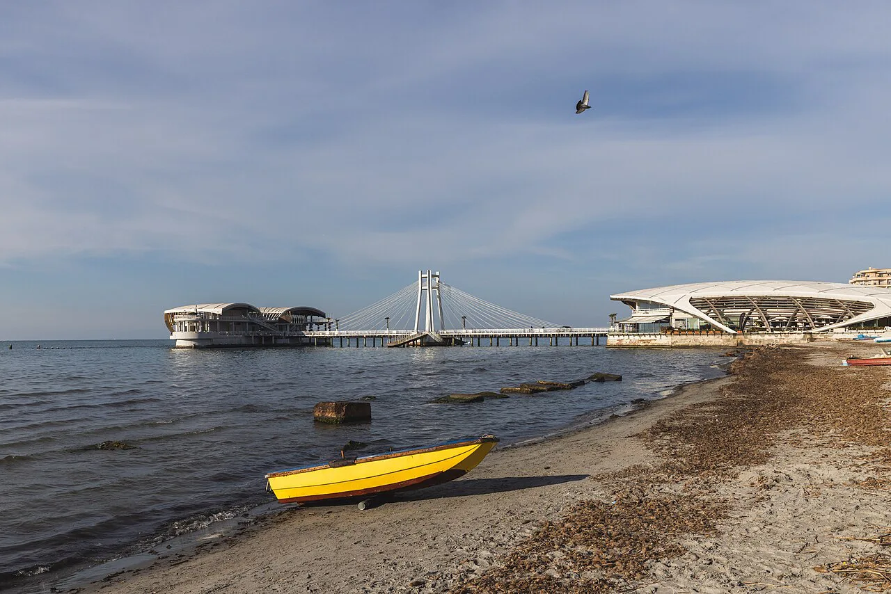 The seafront in Durrës, with a pier stretching into the bay.