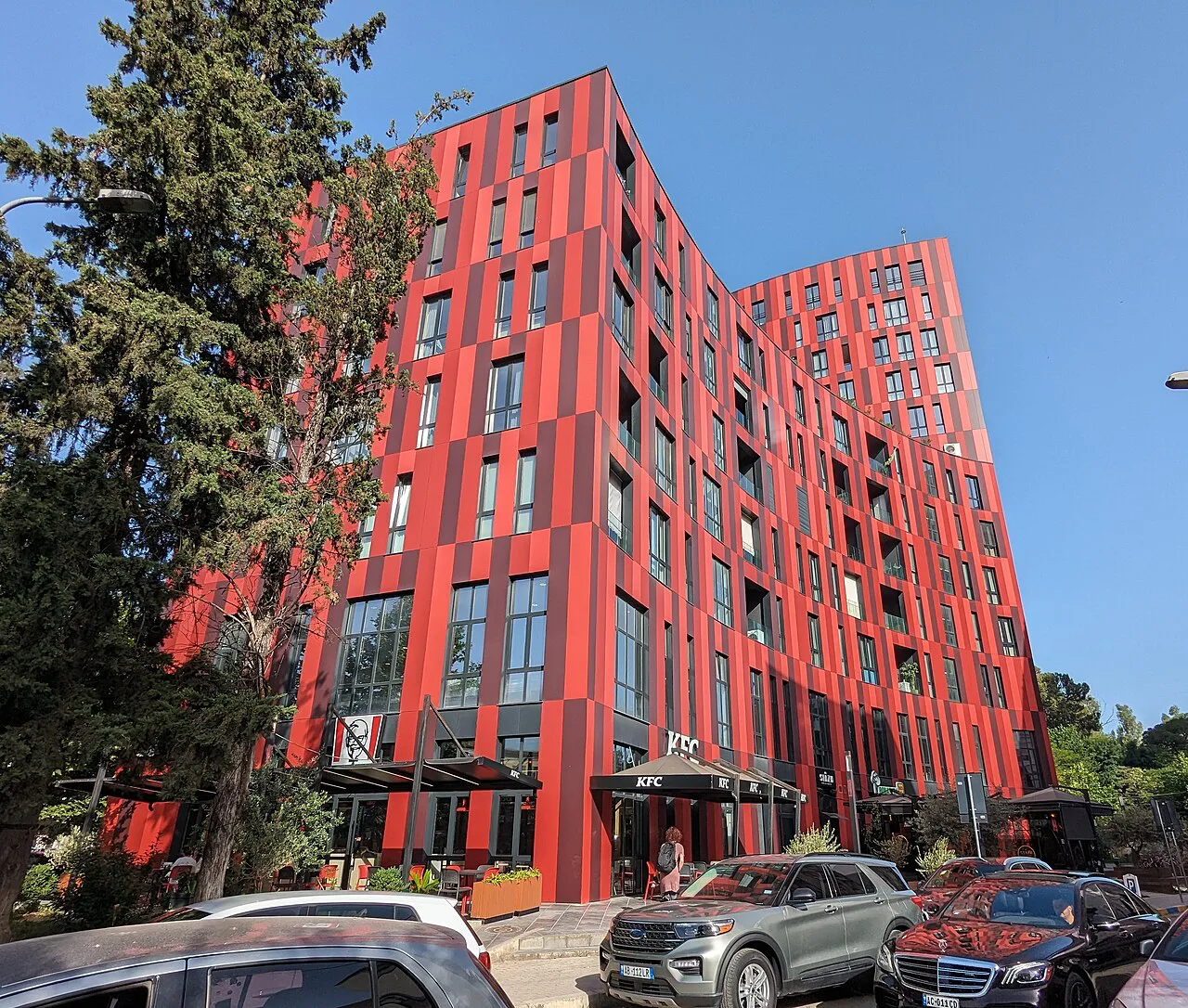 The red façade of the Park Gate building in Tirana.