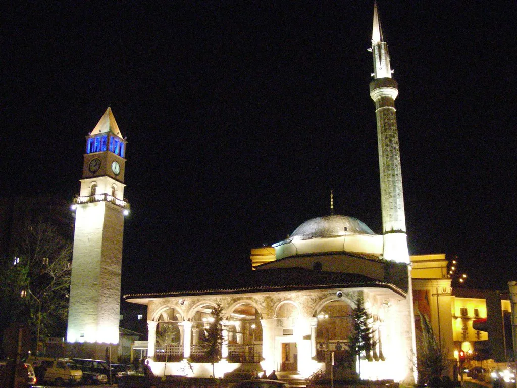 The Clock Tower of Tirana and the Et'hem Bey Mosque lit up at night.