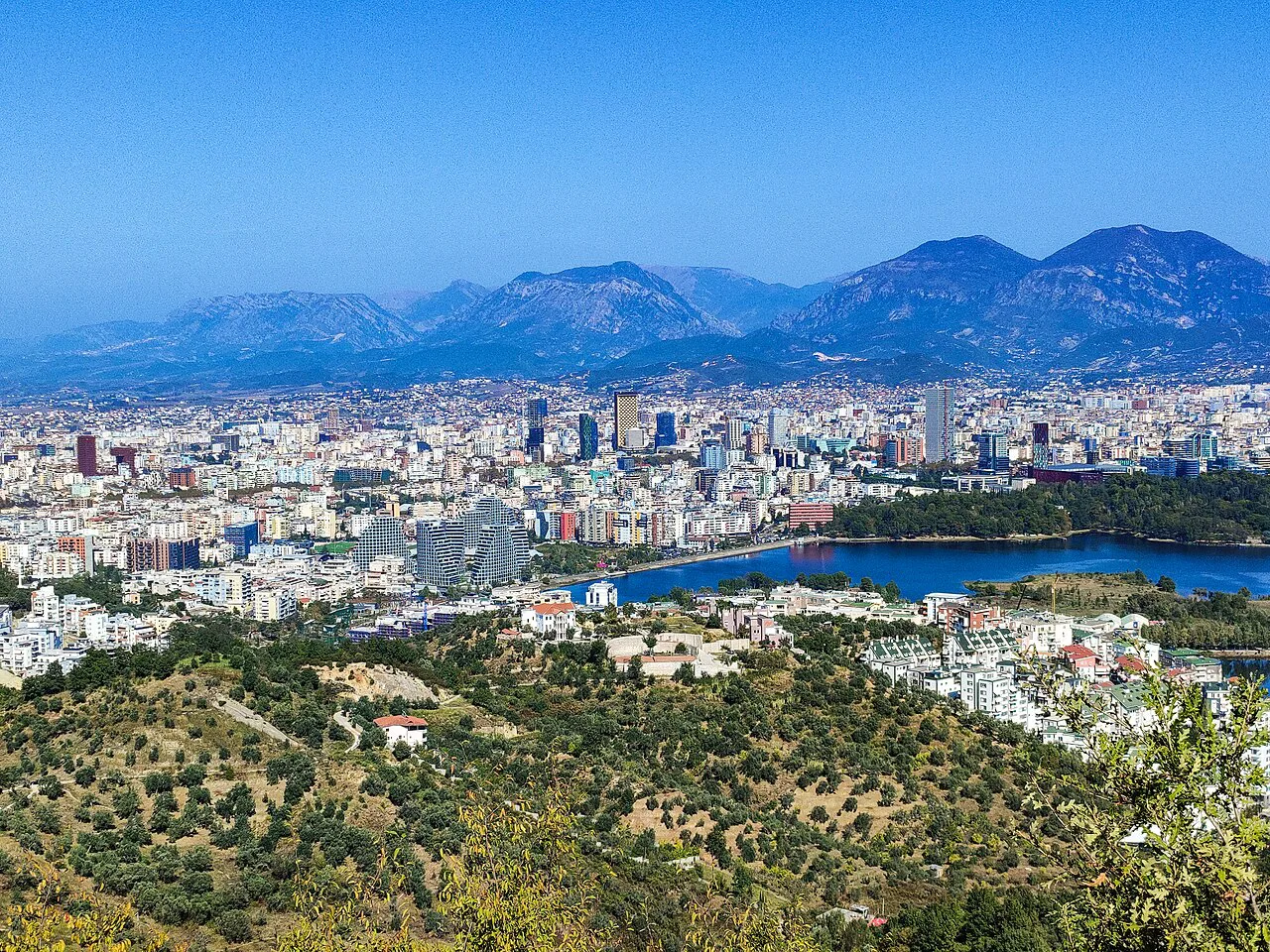 Tirana spread across its plain, seen from the surrounding hills.