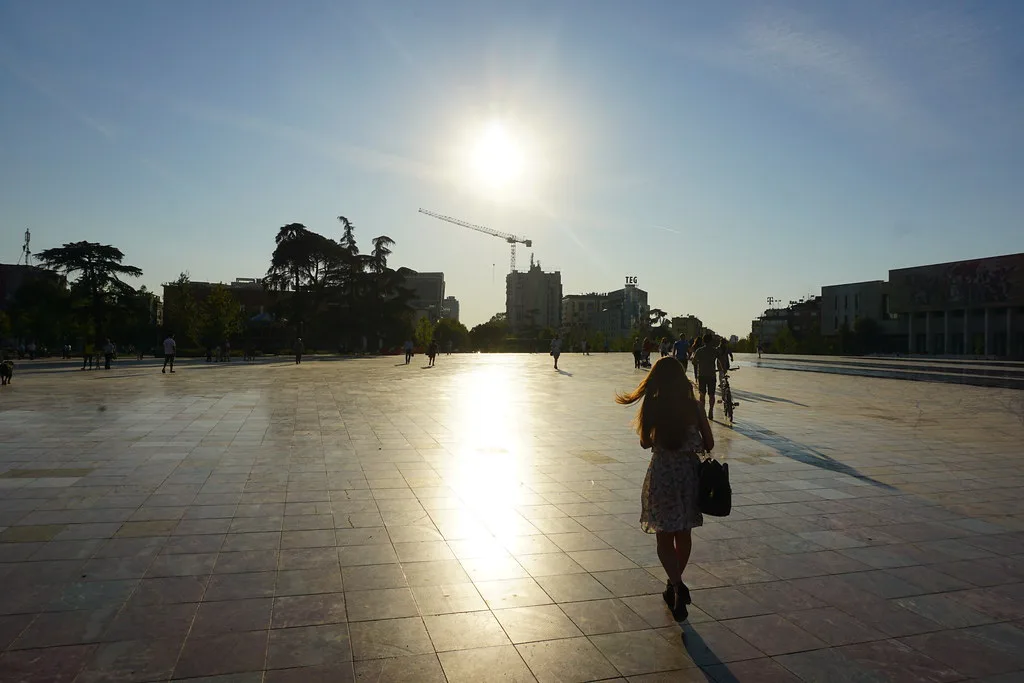 The low sun reflecting off the paving of Skanderbeg Square in Tirana.
