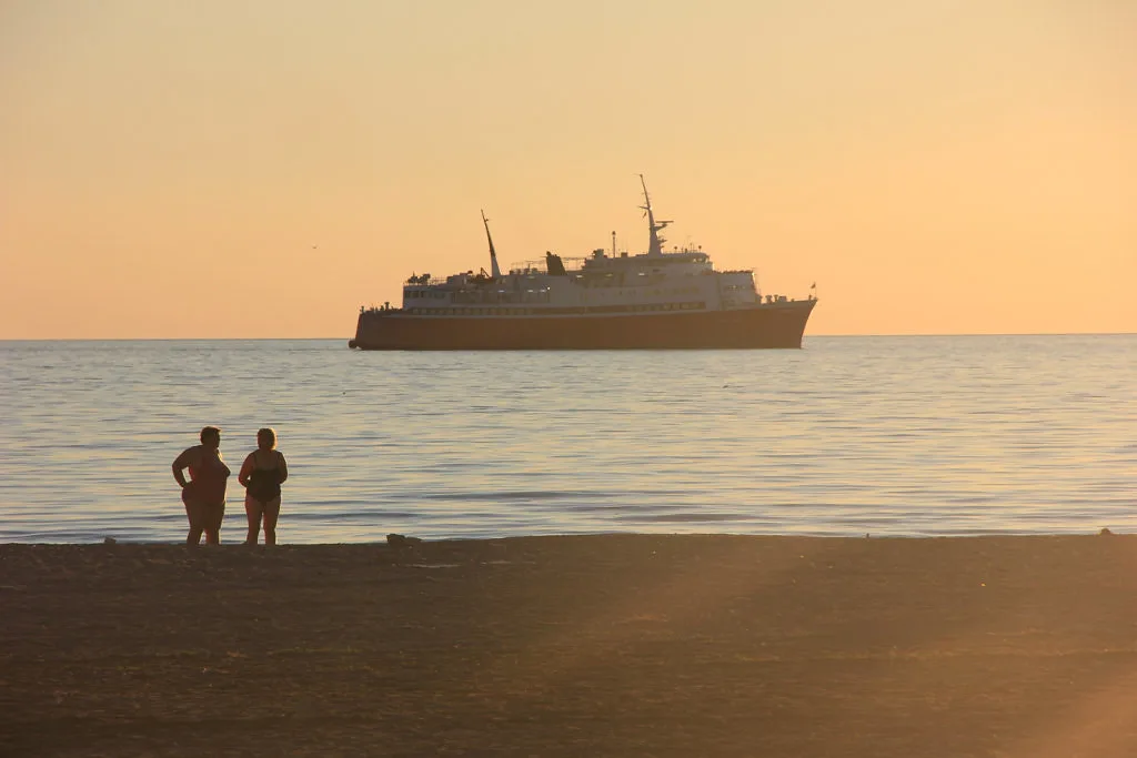 A ship offshore at Vlorë at sunset.