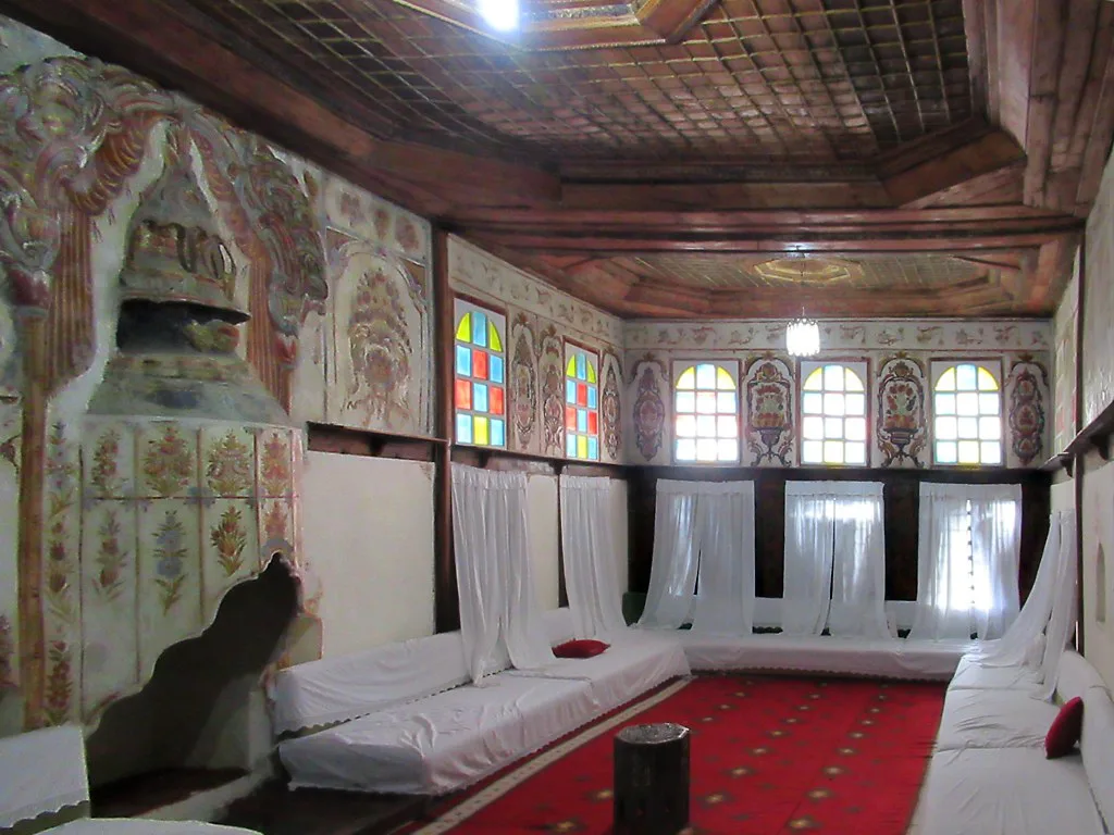The guest room in Zekate House, Gjirokastër, with its carved wooden ceiling.
